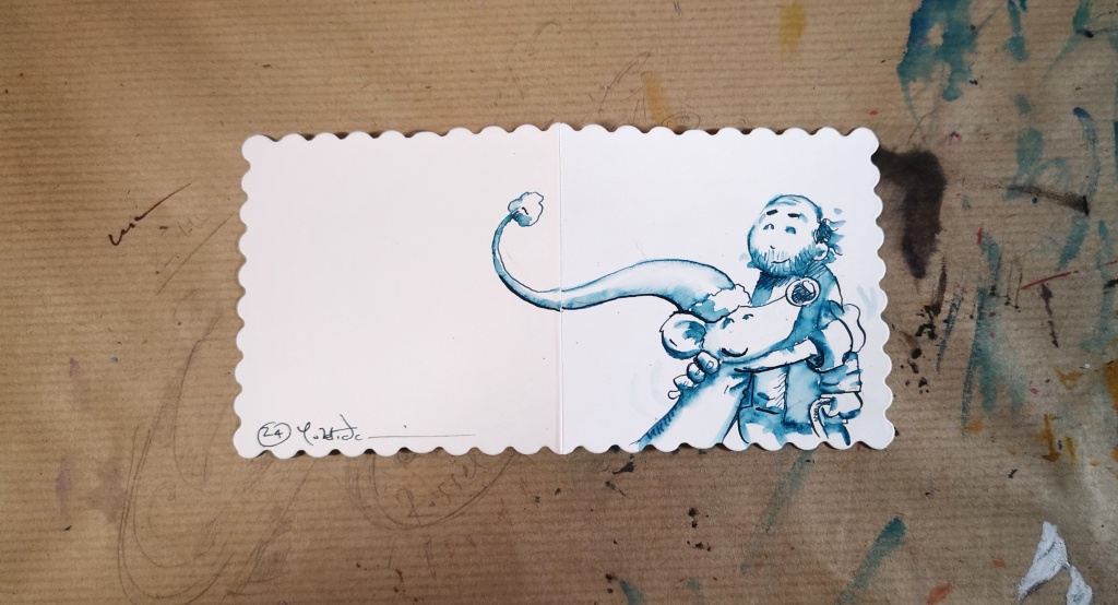 A photograph of a mouse hugging Sir Quentin Blake Christmas card.